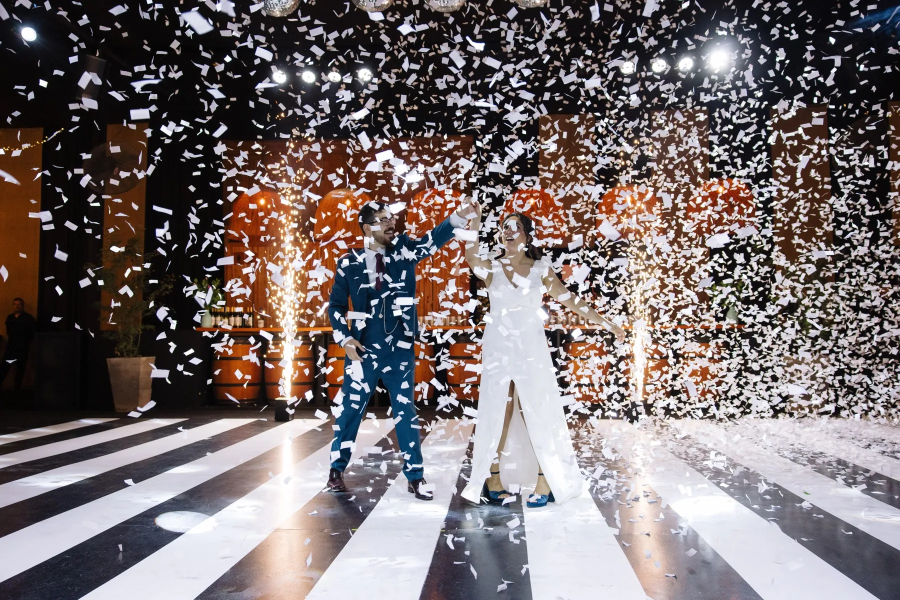 Novios celebrando entre confetti y pirotecnia fria Stellar